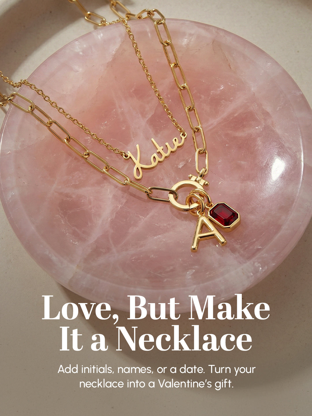 Gold necklace with a red pendant on a pink stone background