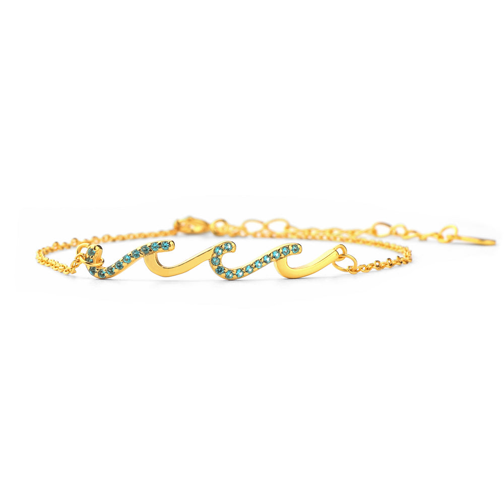A gold-colored triple wave friendship bracelet with sparkling accents on a white background.