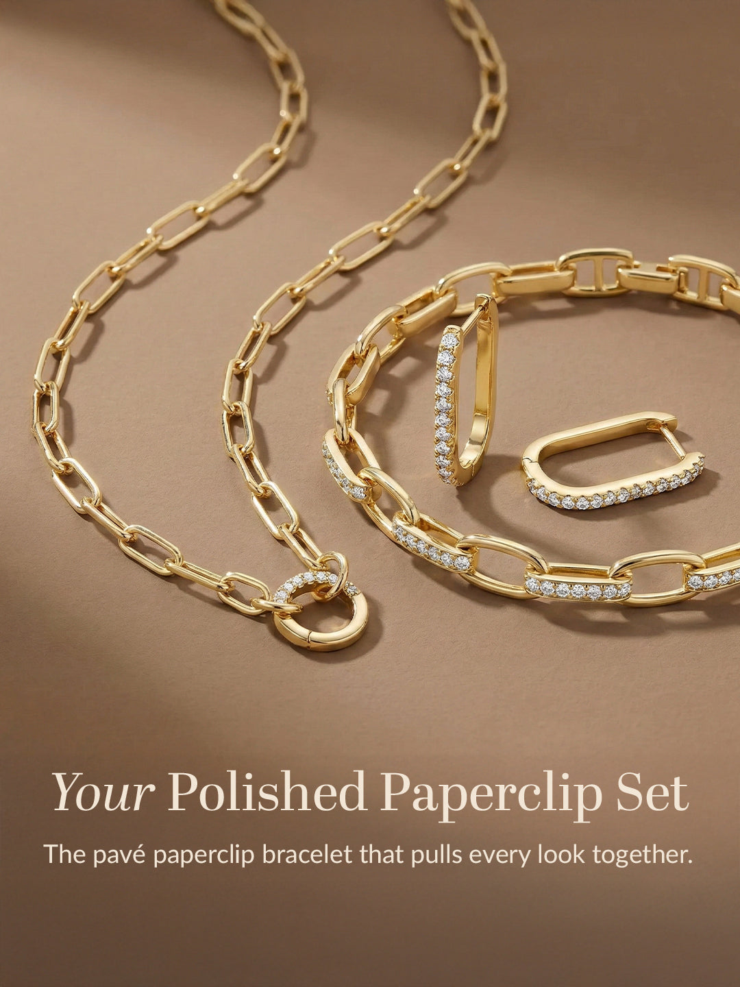 Gold paperclip bracelet with diamond accents on a brown background