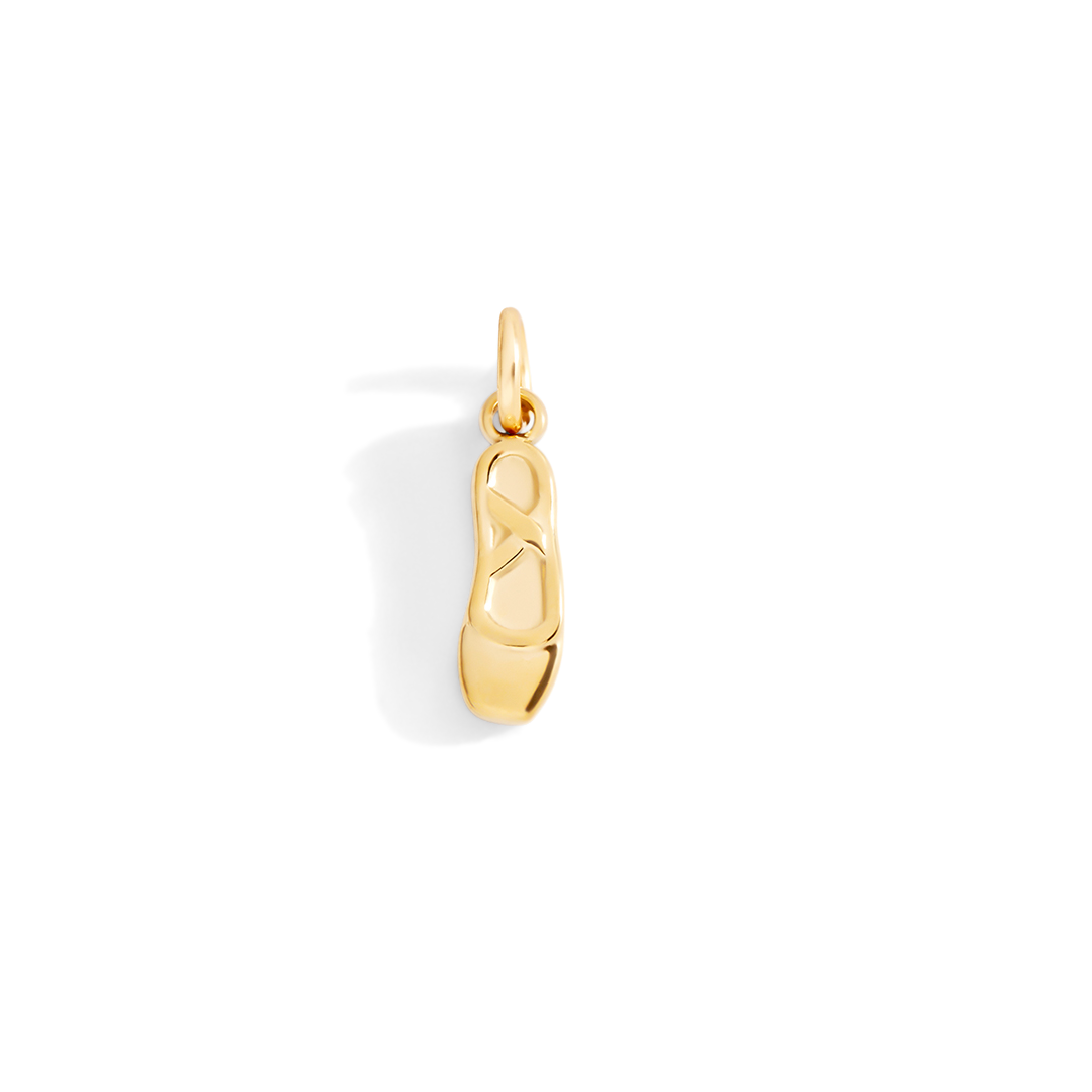 Gold shoe charm on a white background