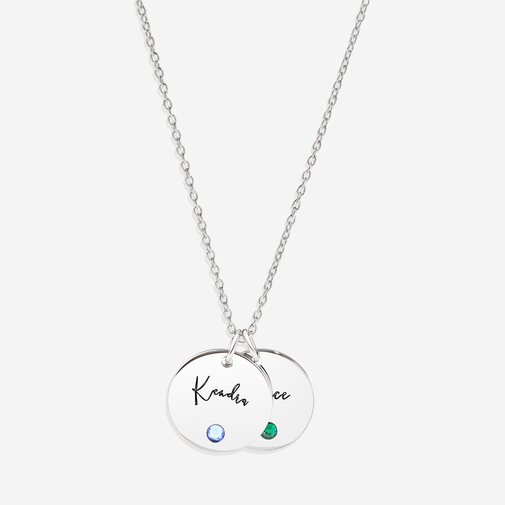 A gold disc name necklace with a birthstone, cable chain, and lobster clasp.
