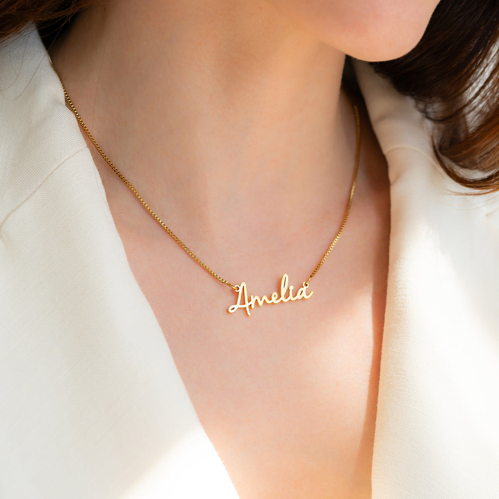 Rose gold 'Lily' necklace on a person wearing a white top