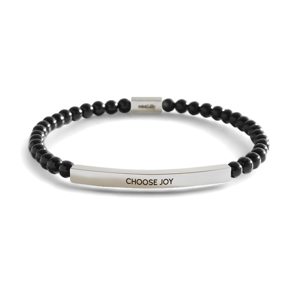 Black beaded bracelet with a silver bar featuring 'CHOOSE JOY' on a light gray background