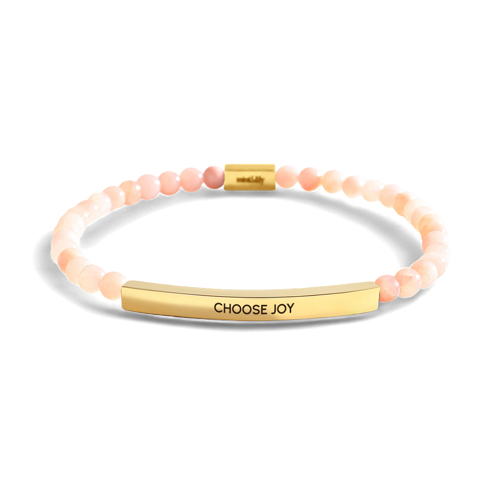 Bracelet with 'CHOOSE JOY' tag on a light gray background
