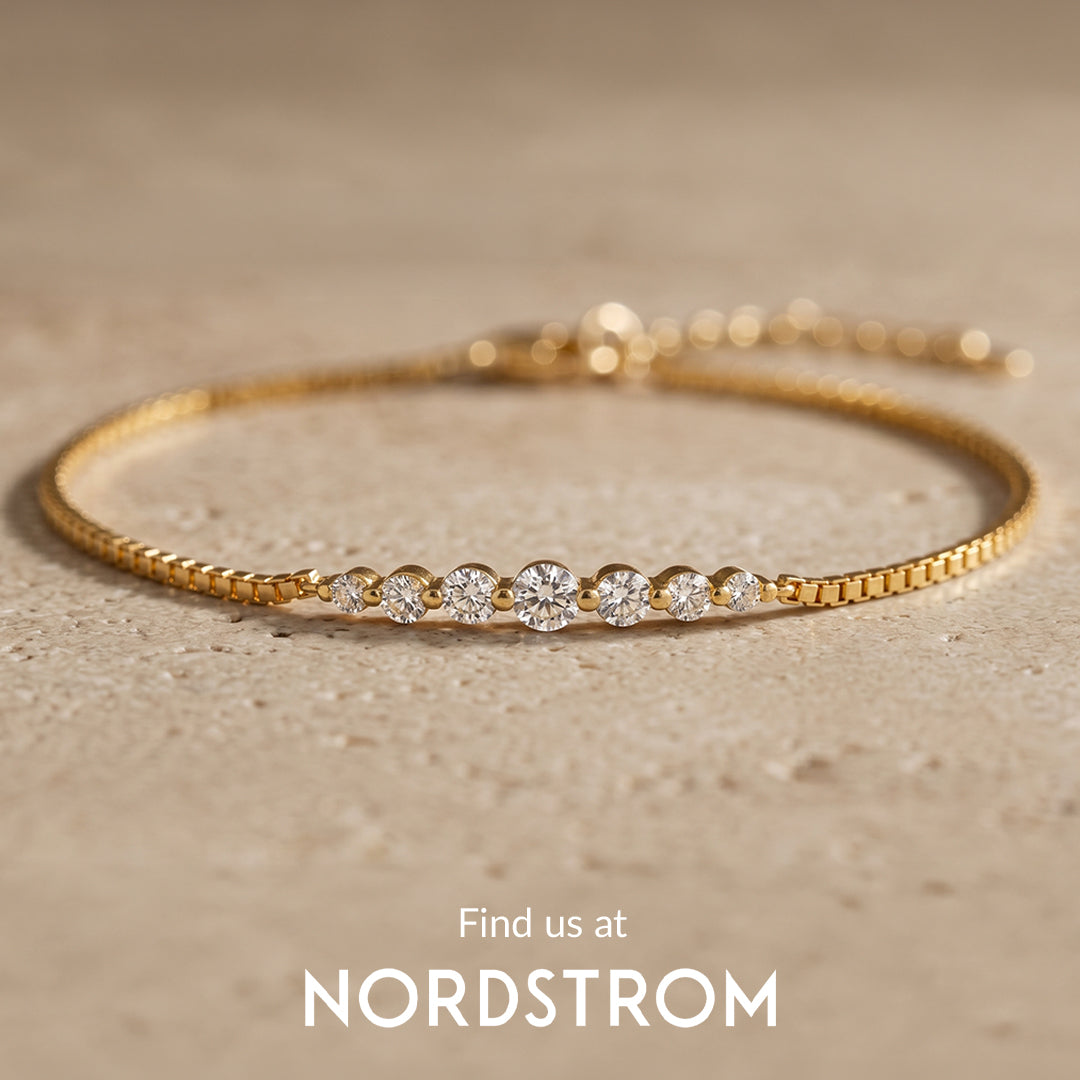 Gold bracelet with small diamonds on a beige background, Nordstrom branding visible.