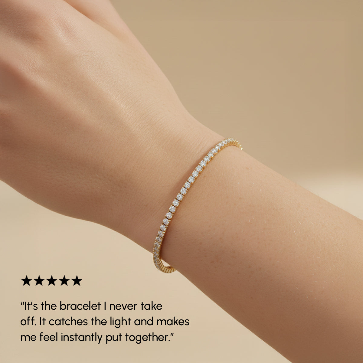 Gold bracelet on a wrist with a neutral background