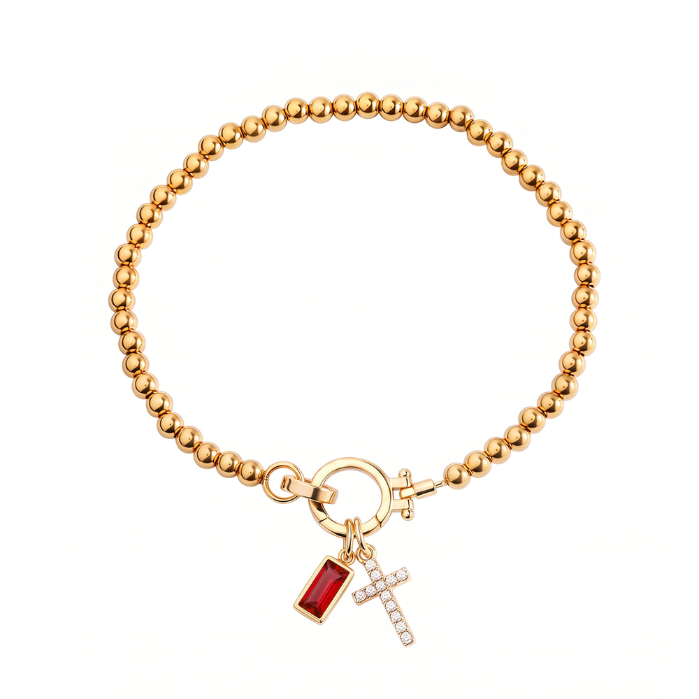 Cross Charm Birthstone Bracelet with gold beaded chain, cross charm and January garnet birthstone charm on a white background.