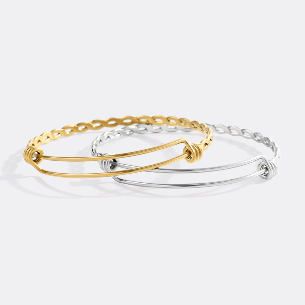 Gold and silver bangles on a light gray background