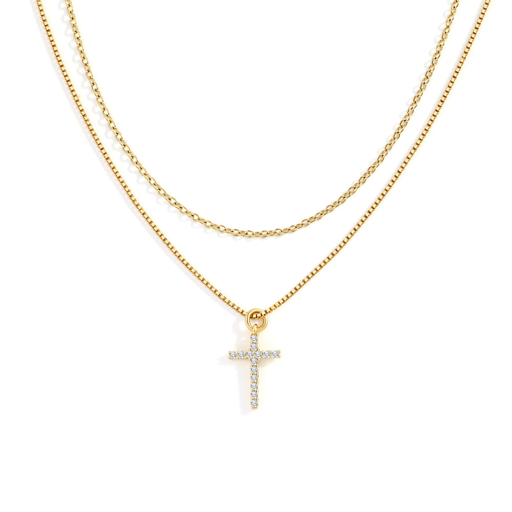 Gold necklace with a cross pendant on a white background