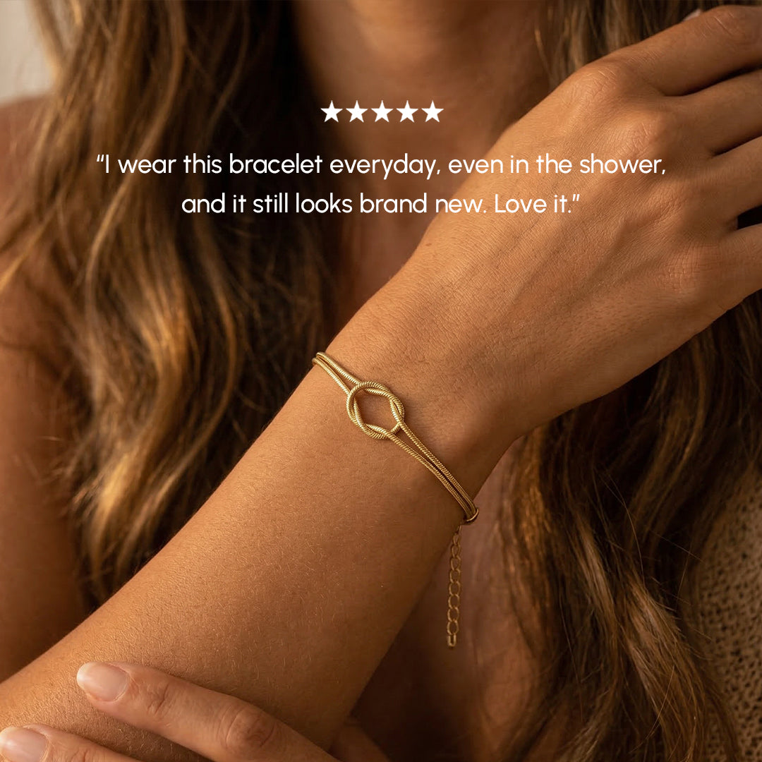 Gold bracelet worn on a wrist with a five-star rating and customer review text.