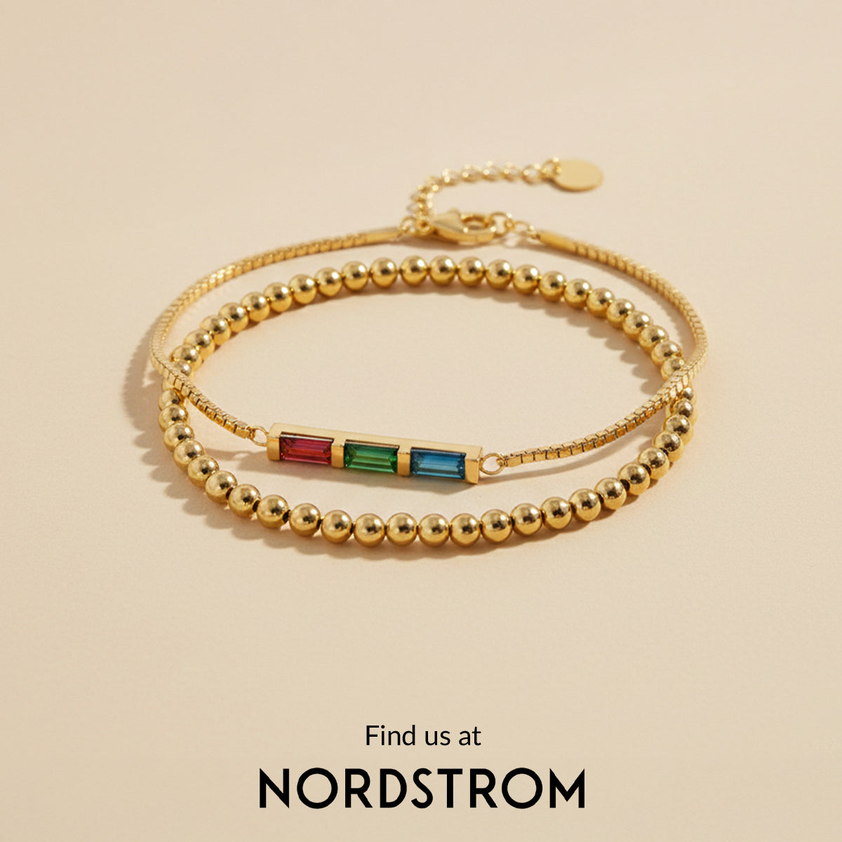 Gold beaded bracelet with colored stones on a beige background, Nordstrom branding visible.