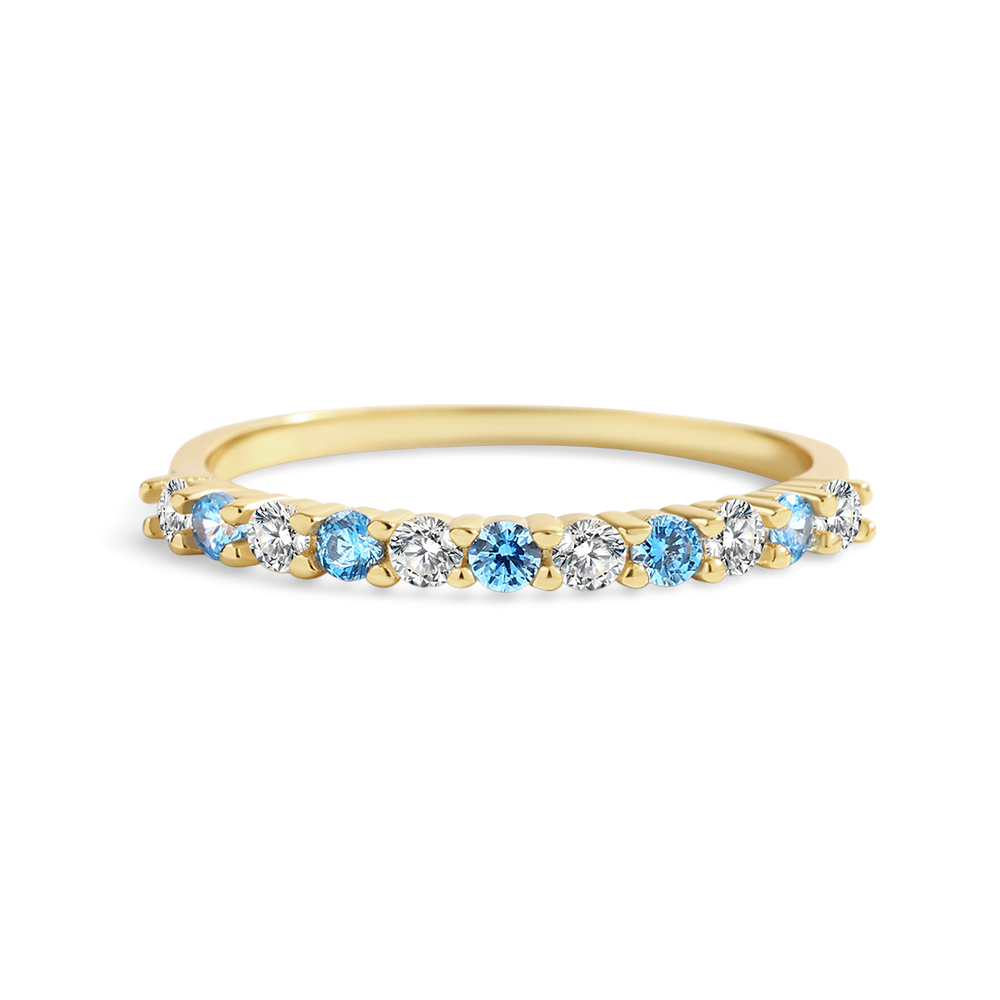 Gold ring with blue and clear gemstones on a white background
