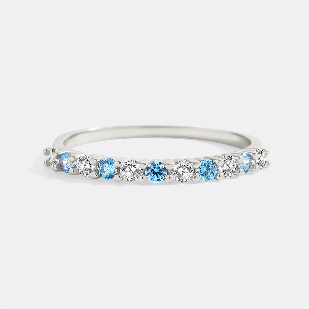 Silver ring with blue and clear gemstones on a white background