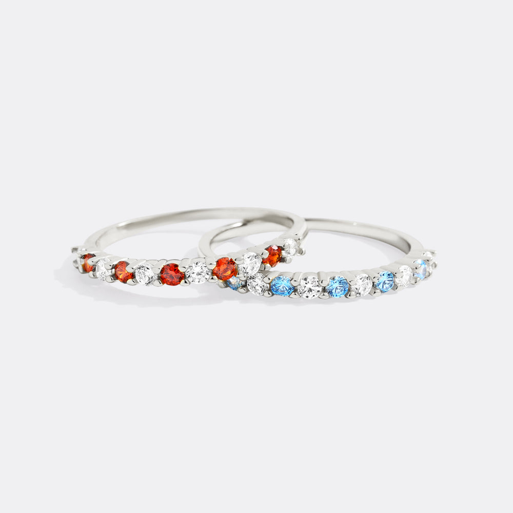 Silver ring with colorful gemstones on a white background