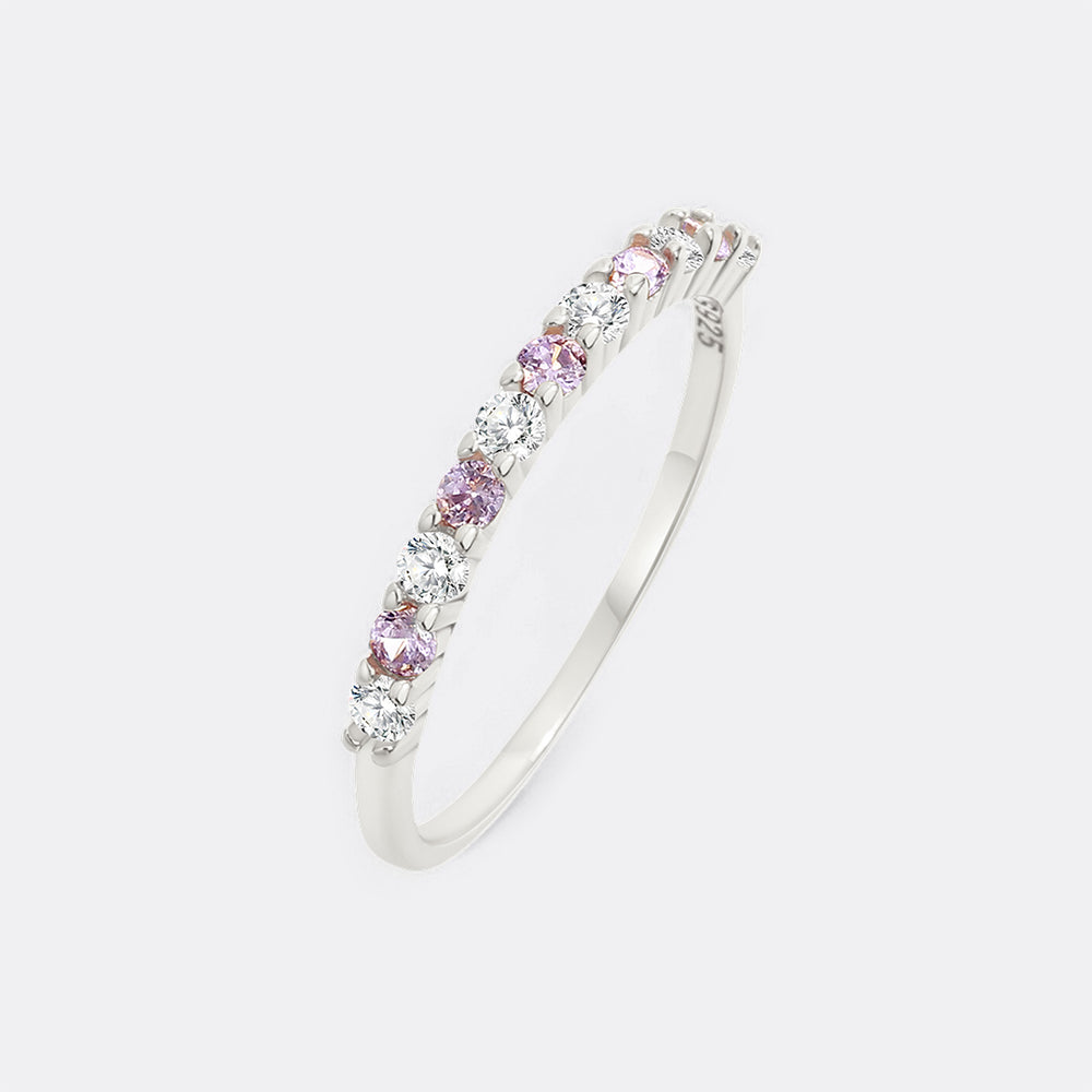 Silver bracelet with pink and clear gemstones on a light gray background