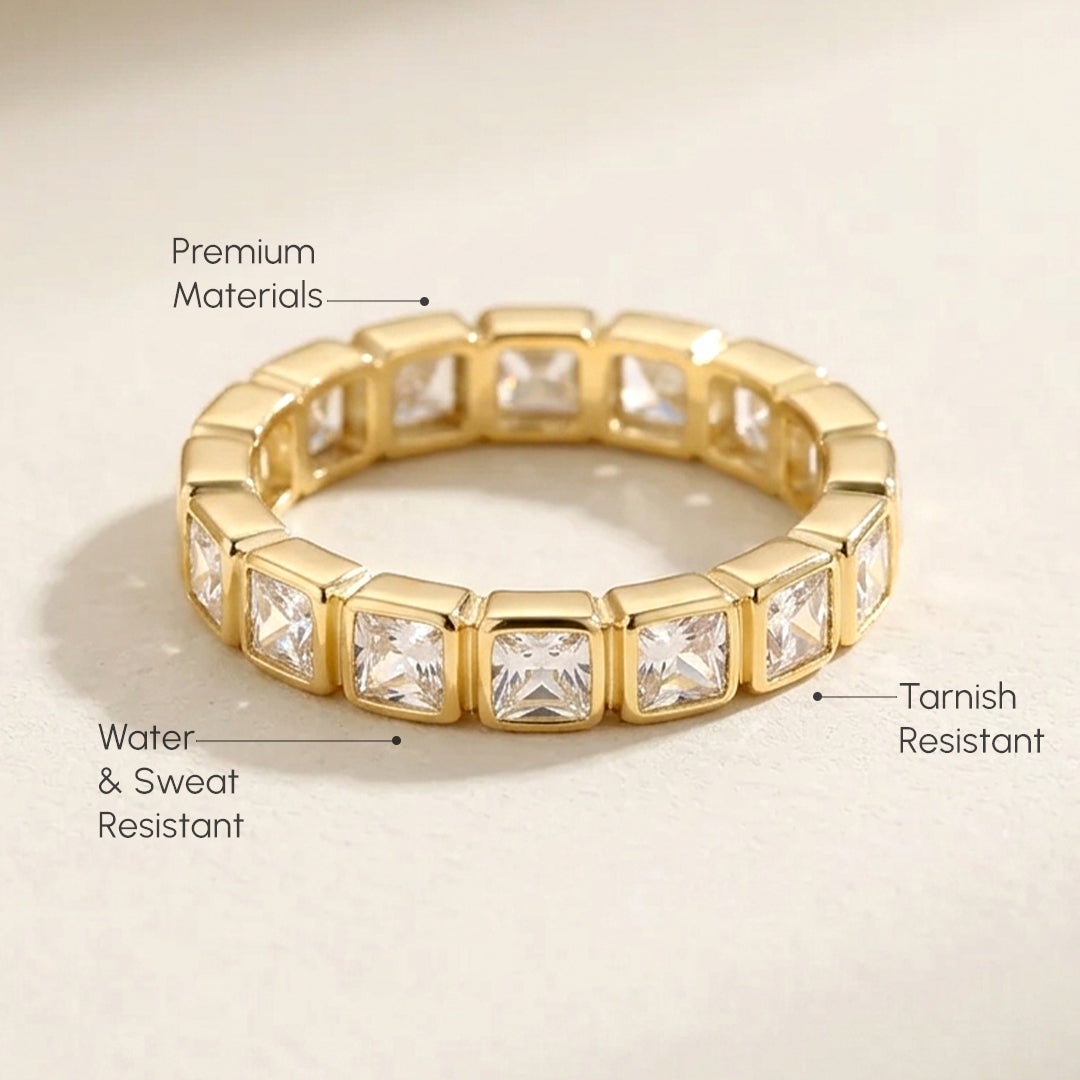 Gold ring with blue stones on a beige background