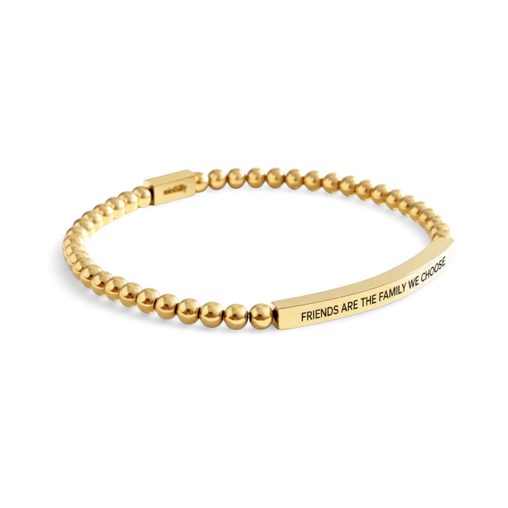 Gold beaded bracelet with engraved message on a white background