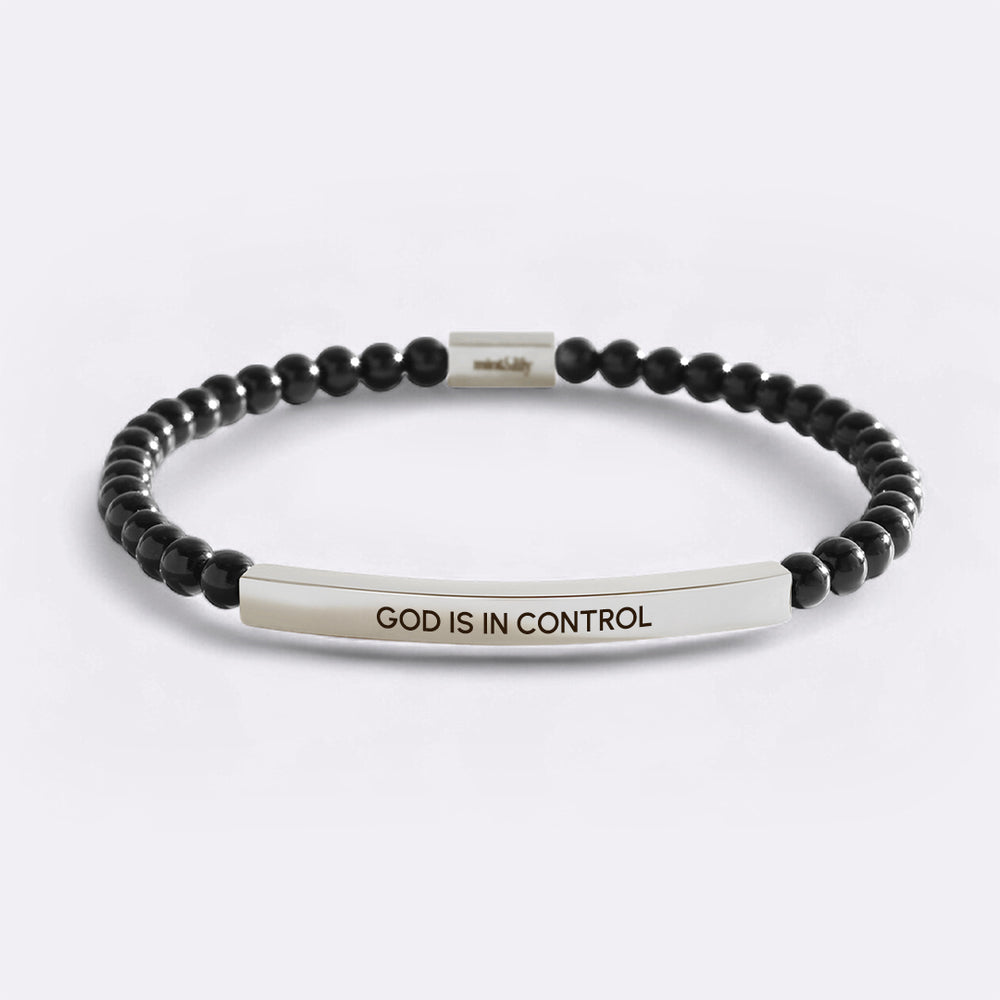 Black beaded bracelet with a silver bar featuring 'GOD IS IN CONTROL' on a light gray background