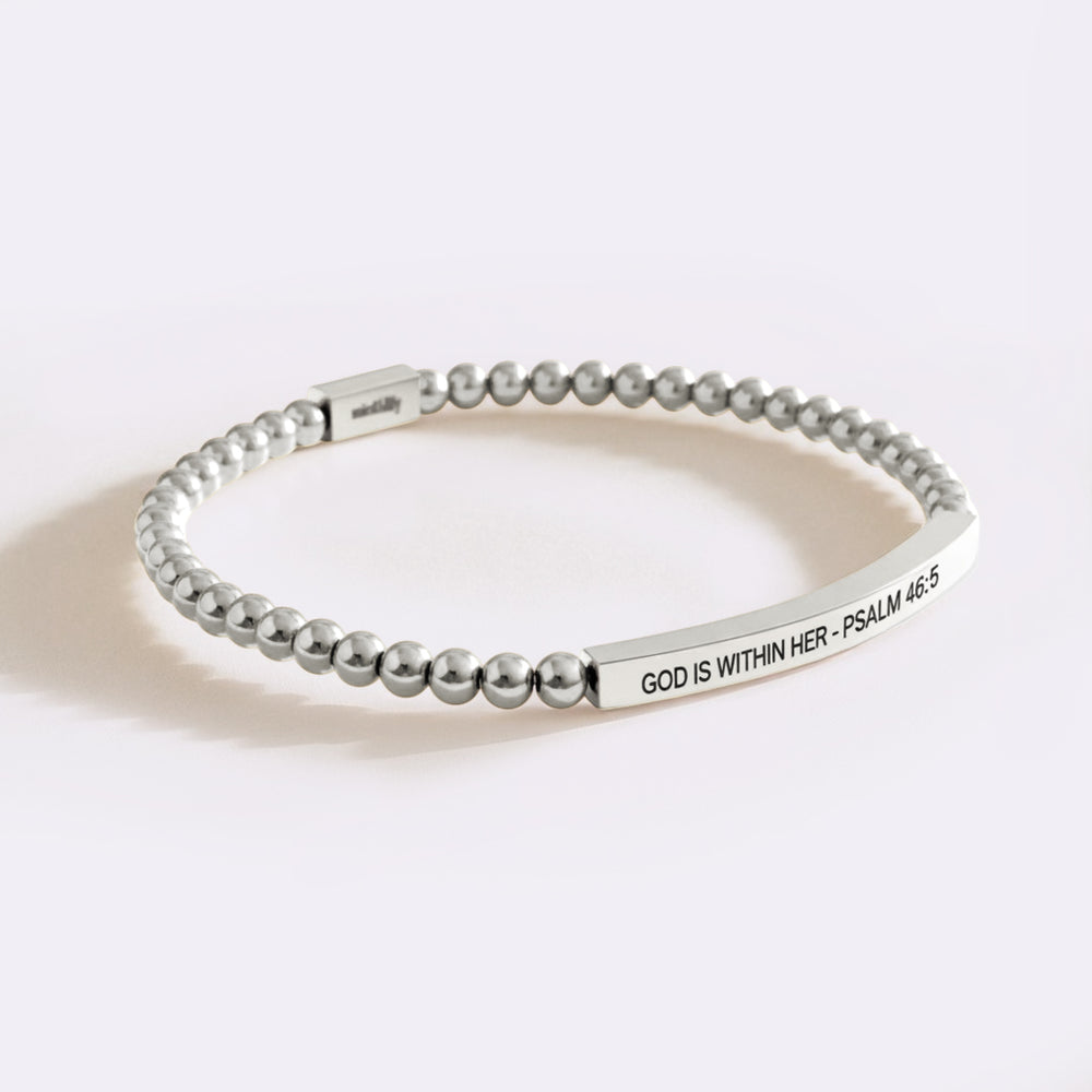Silver beaded bracelet with engraved text on a white background
