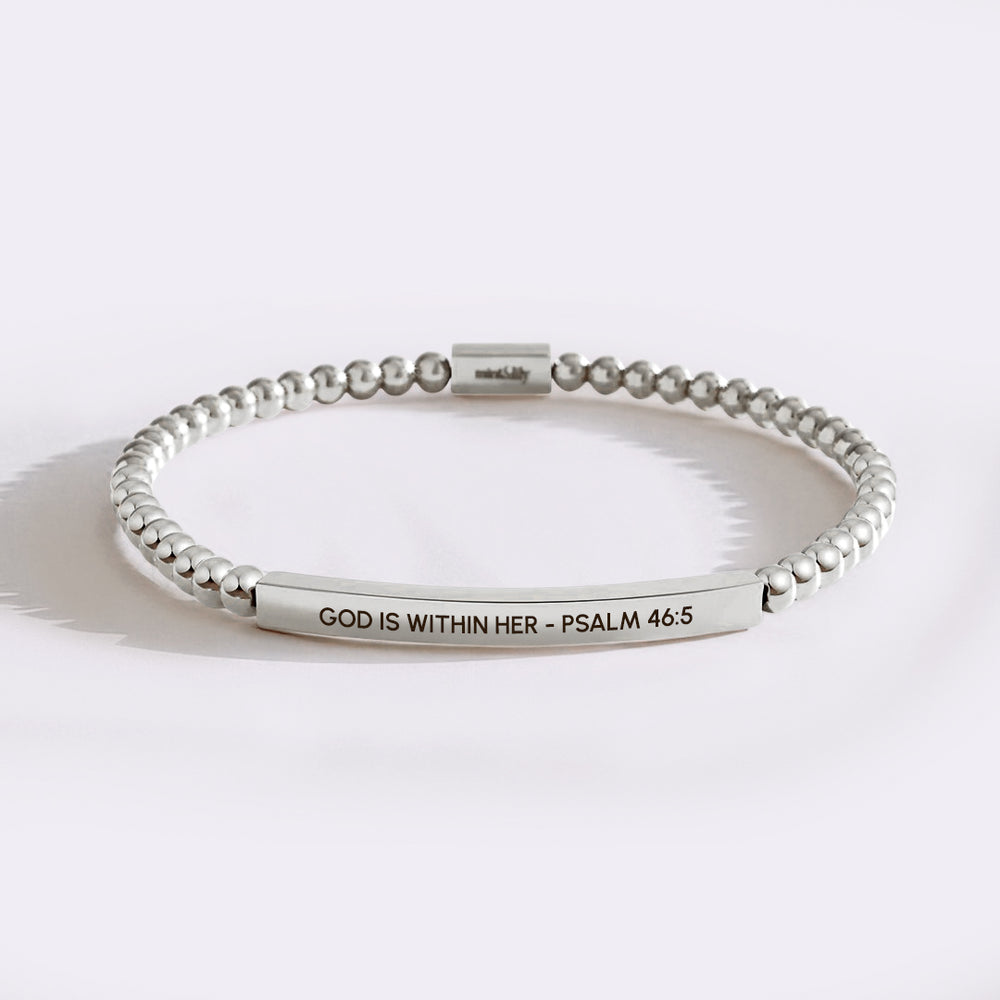 Silver beaded bracelet with engraved text on a white background
