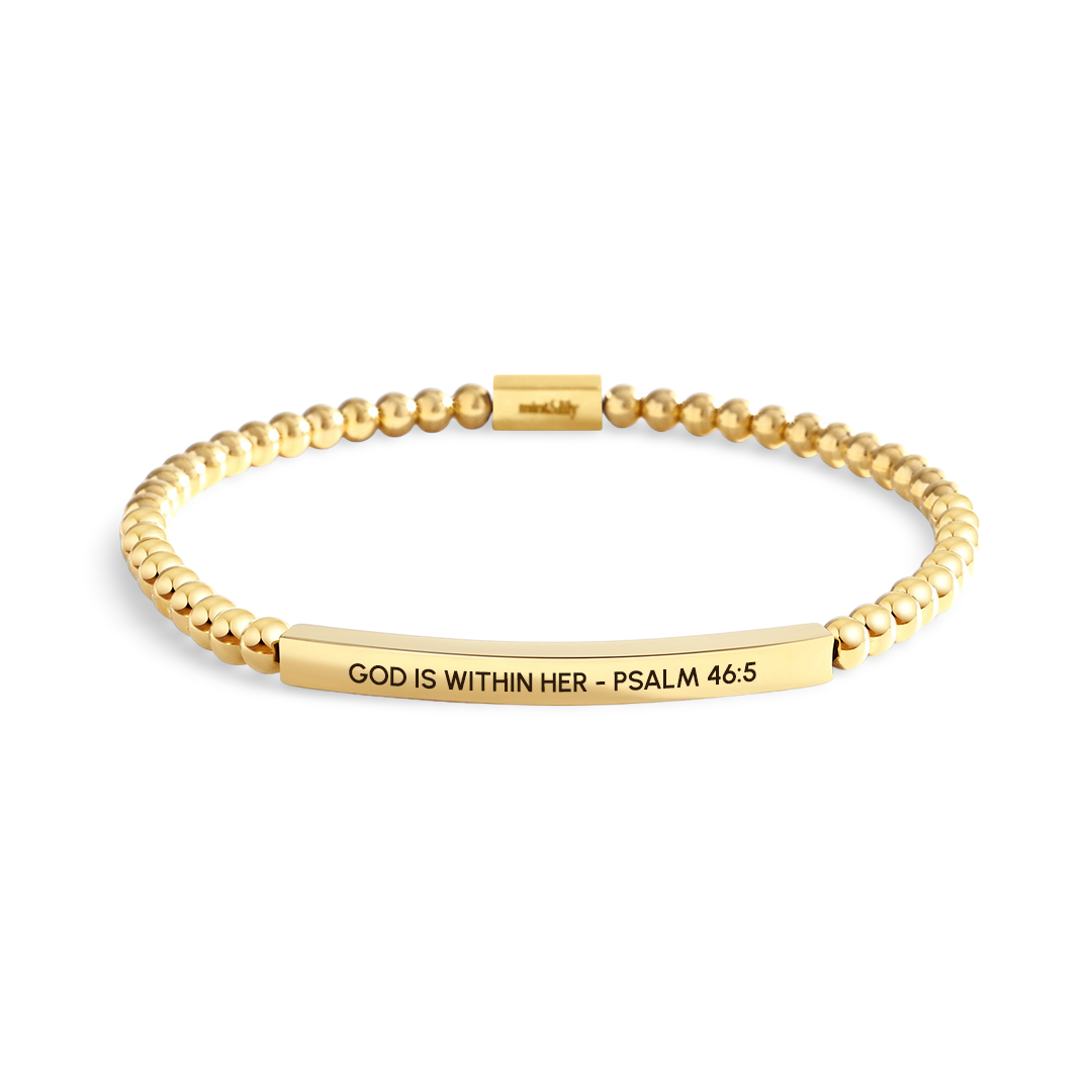 Gold bracelet with engraved text on a white background
