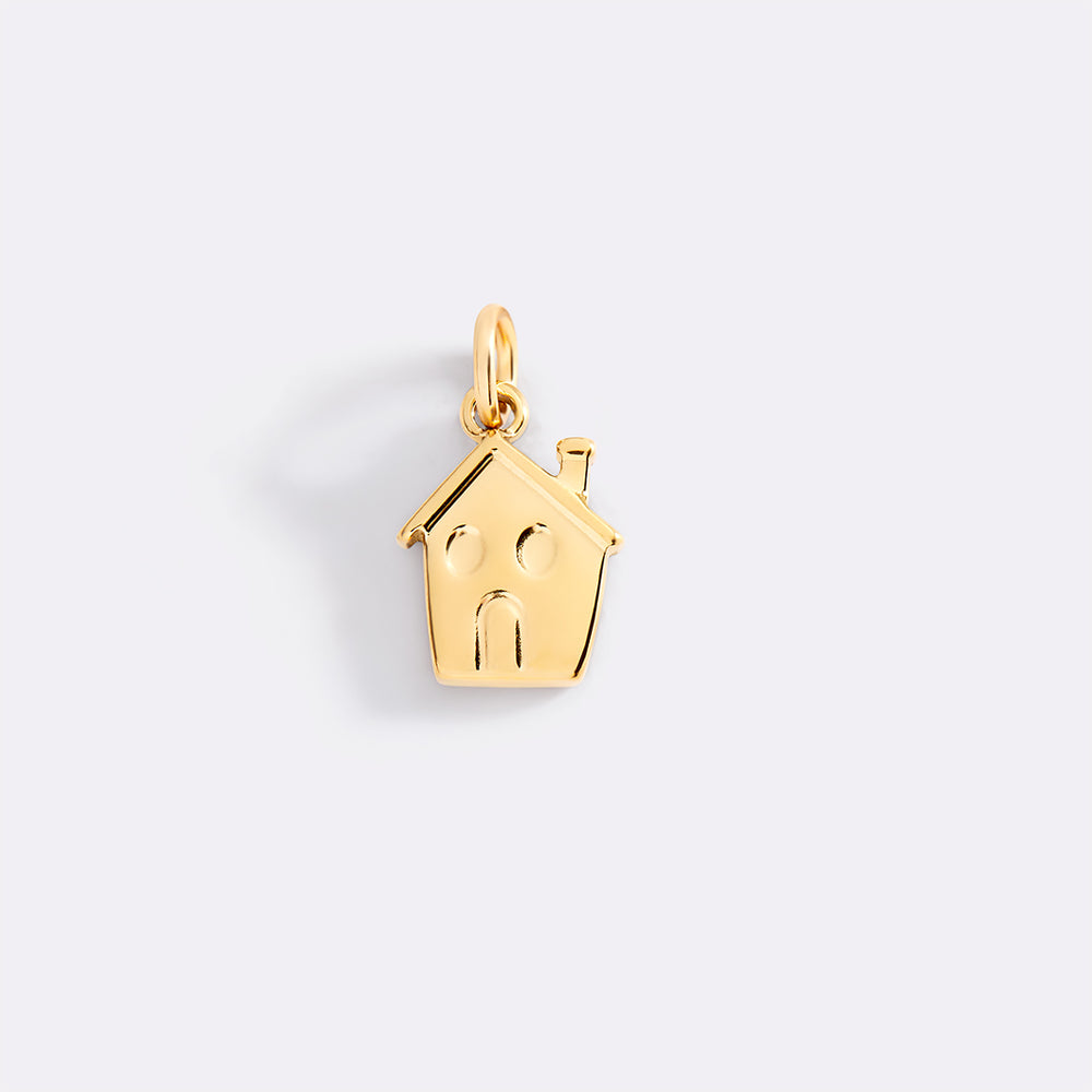 Gold house-shaped pendant with a family design on a light gray background