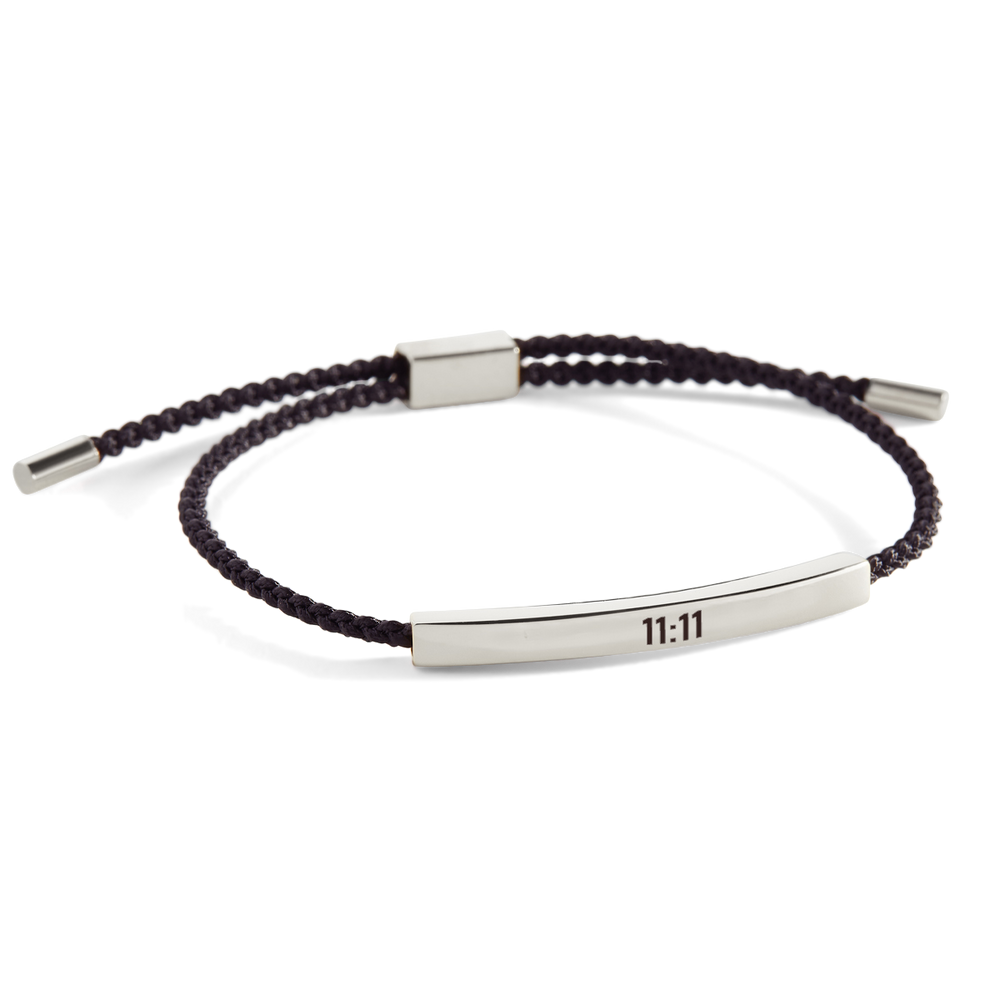 A silver braided bracelet with a sleek metal tube charm displaying the time '11:11', set against a white background.