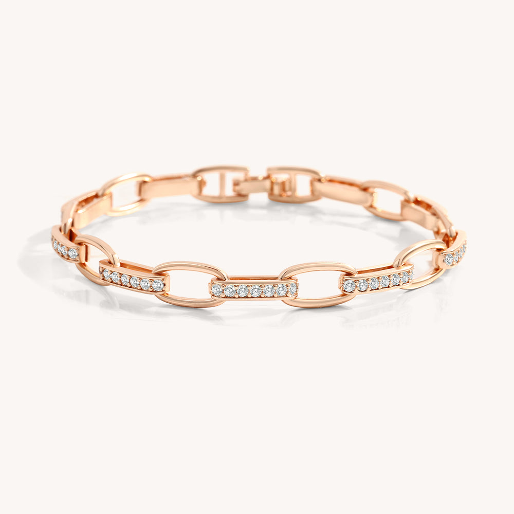 Rose gold bracelet with diamond accents on a white background