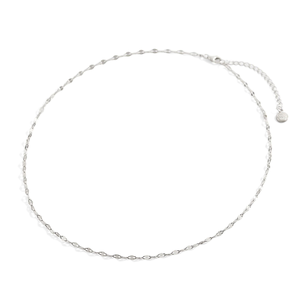 Silver chain necklace on a light gray background