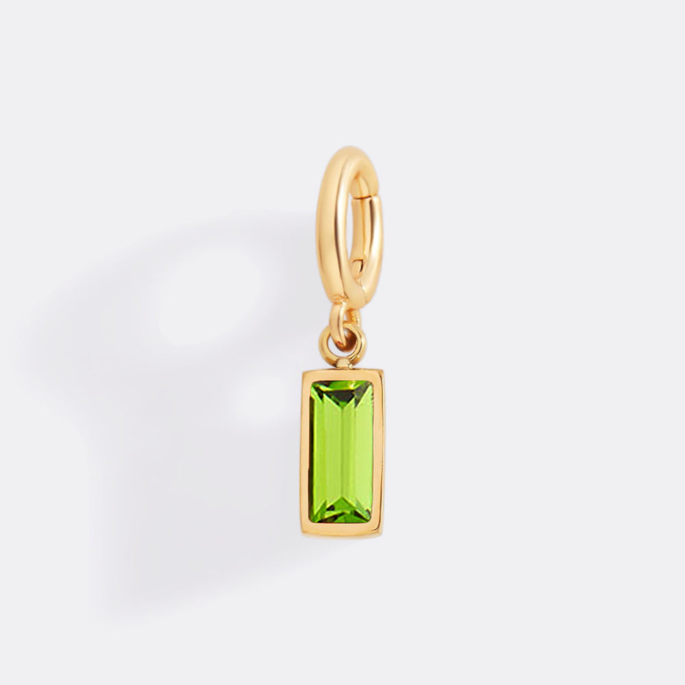 Gold pendant with a green gemstone on a white background