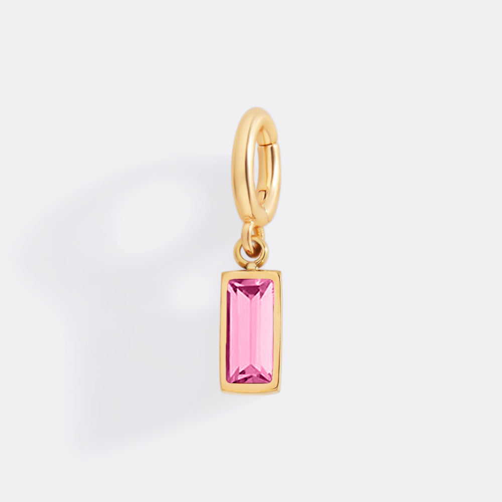 Gold pendant with a pink gemstone on a white background
