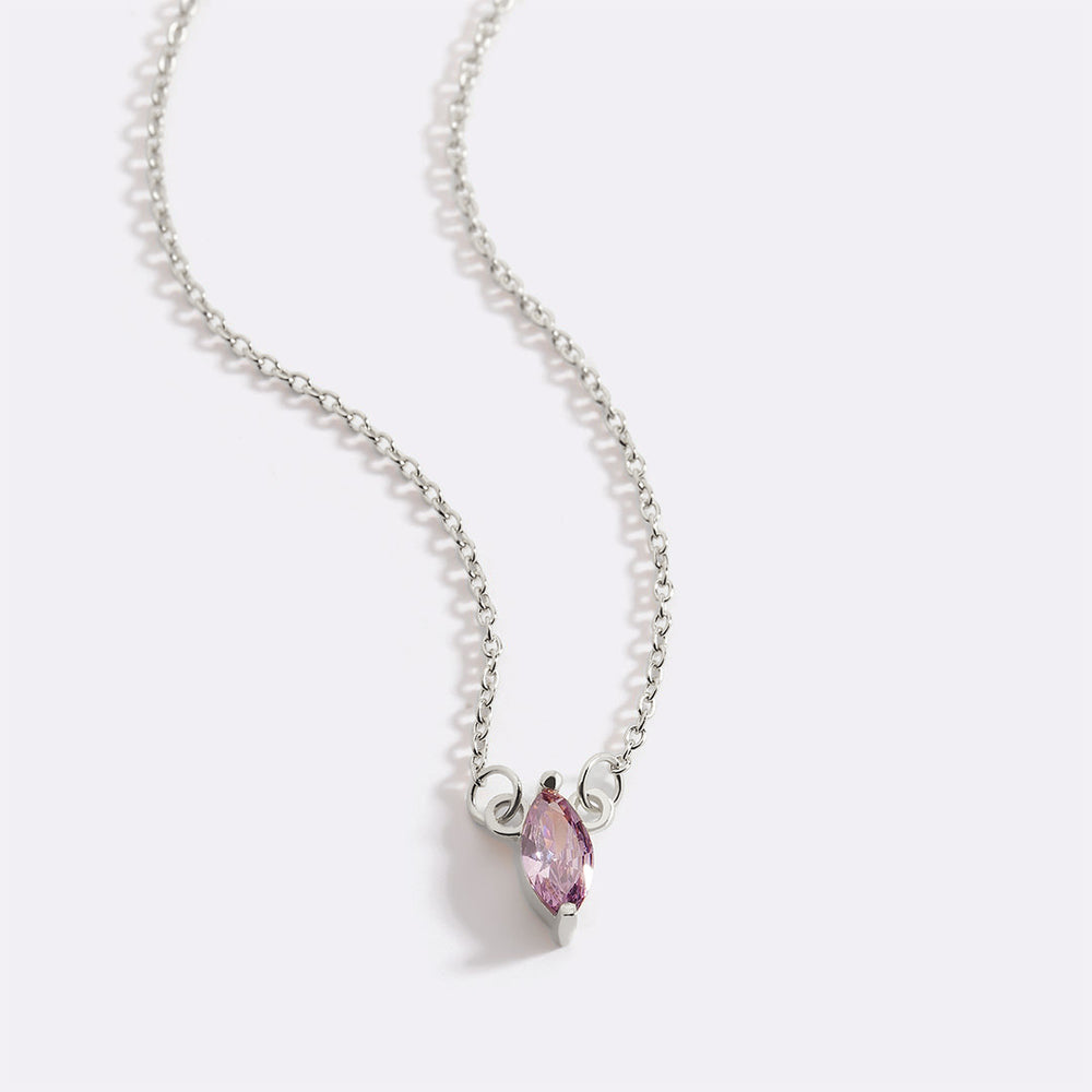 Silver necklace with a pink gemstone on a white background