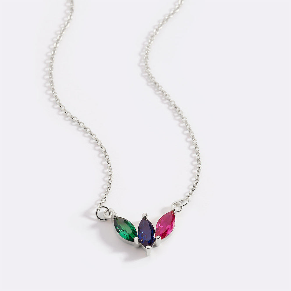Necklace with three colored gemstones on a white background
