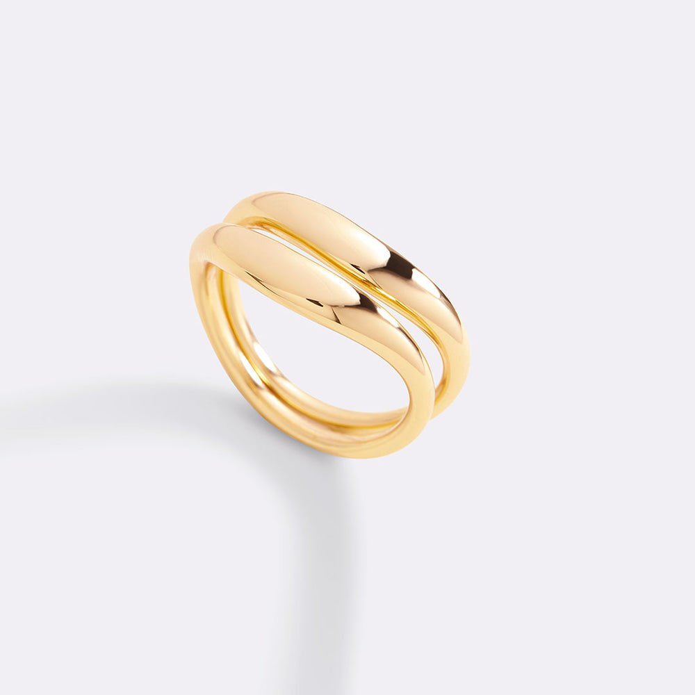 Gold ring on a light gray background