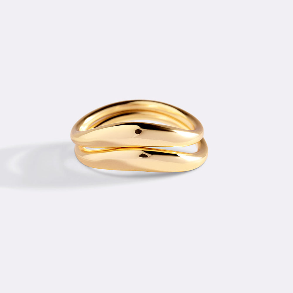 Gold ring on a light gray background