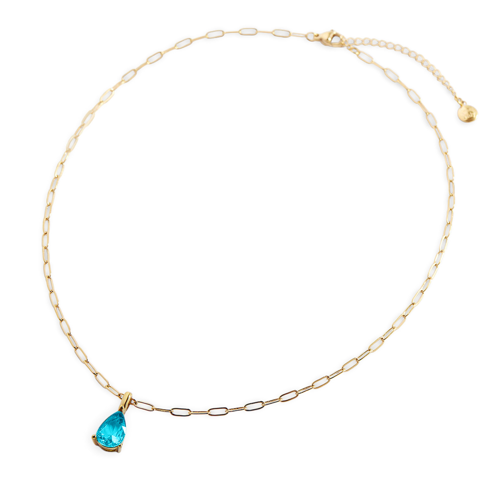 Gold necklace with a blue teardrop pendant on a white background