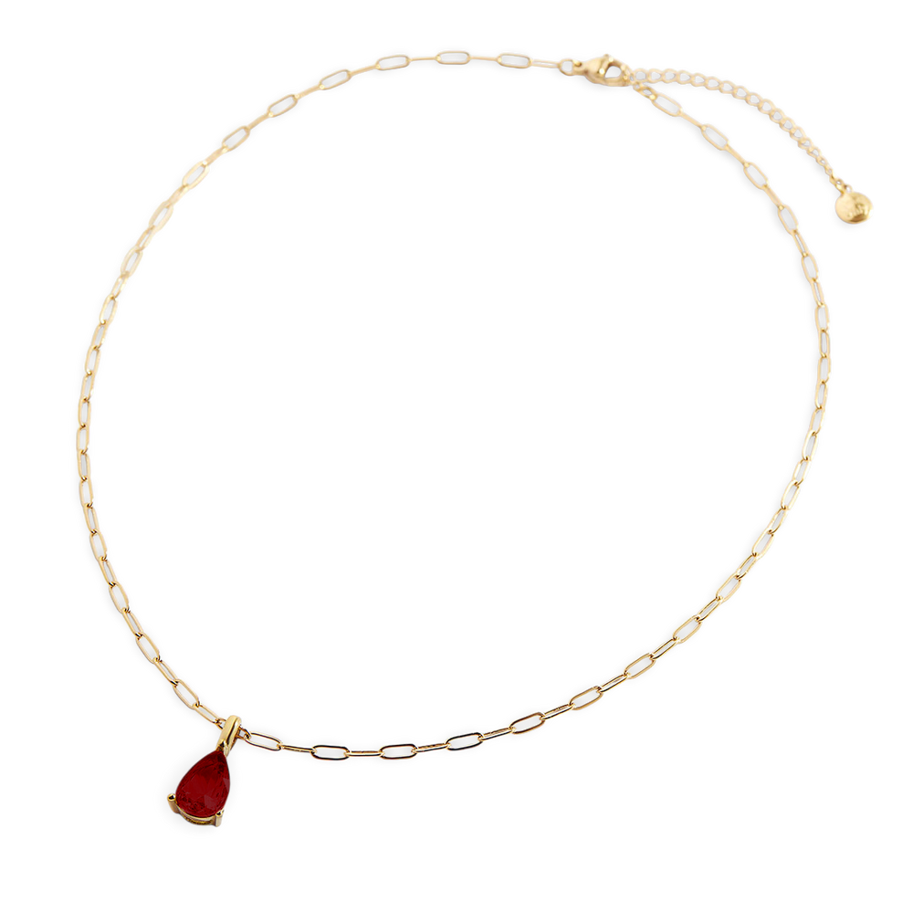 Gold necklace with a red teardrop pendant on a white background