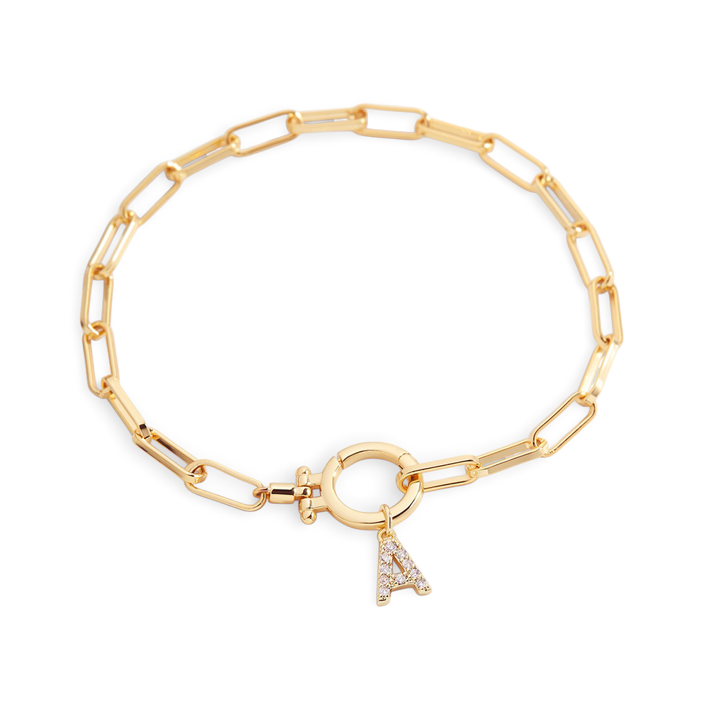 Gold chain bracelet with a charm on a white background