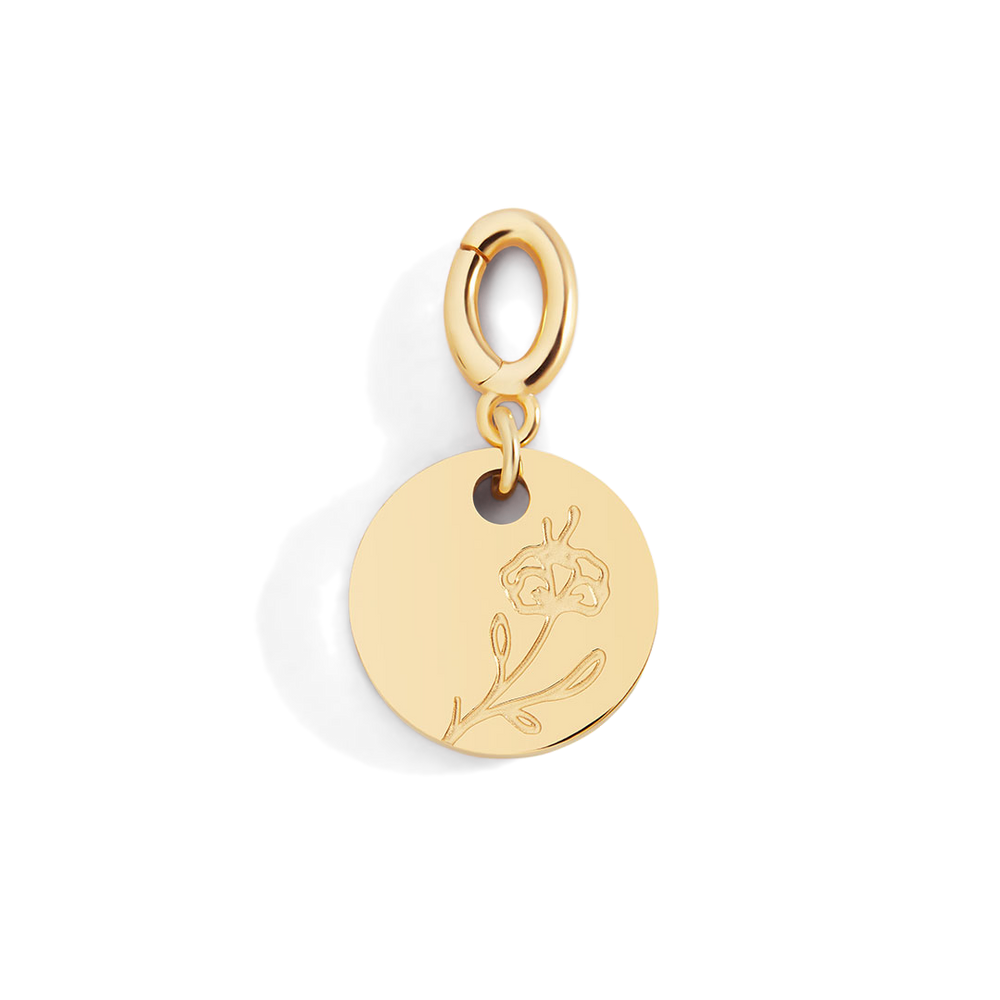 Gold pendant with floral design on a light gray background
