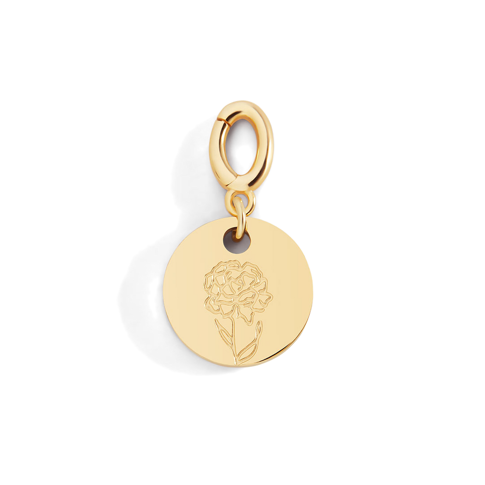 Gold pendant with a floral design on a light gray background