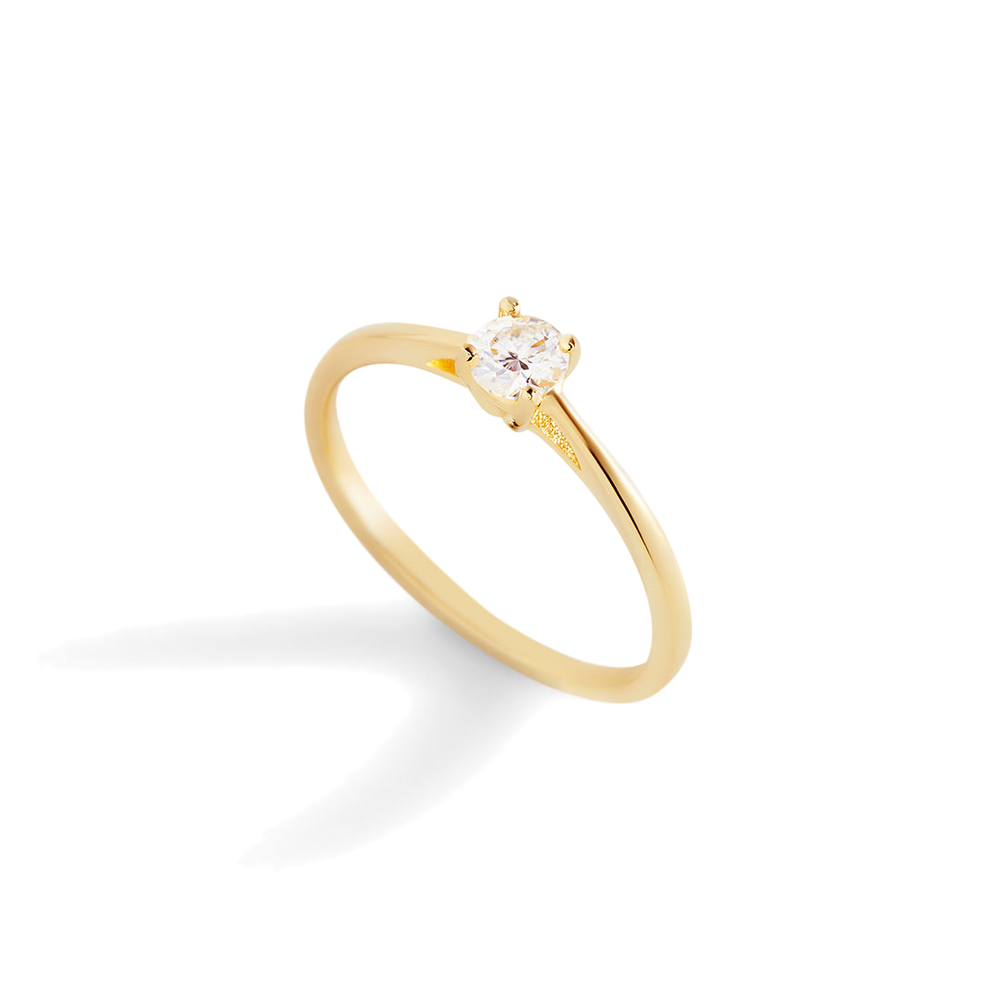 A gold solitaire ring with a single sparkling diamond set in a prong setting.