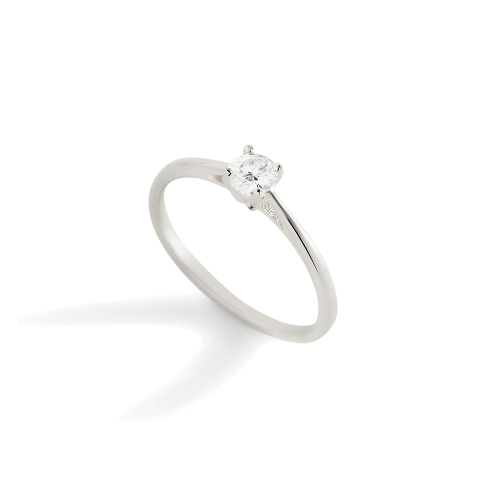 A gold solitaire ring with a single sparkling diamond set in a prong setting.