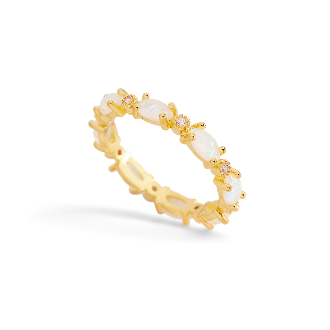 Gold ring with pearls on a light gray background