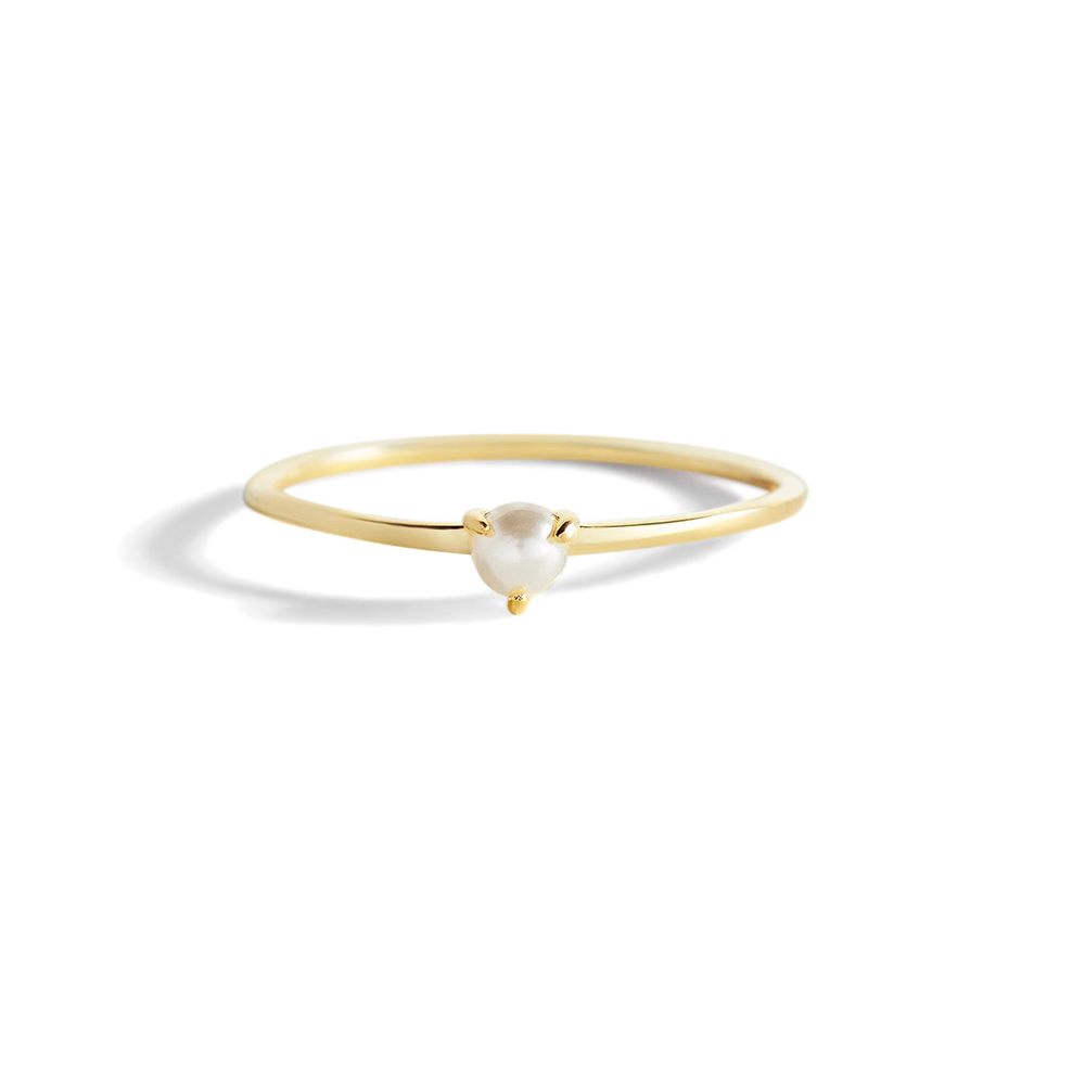 A gold-colored stacking ring with a single freshwater pearl at the top, displayed against a black background.