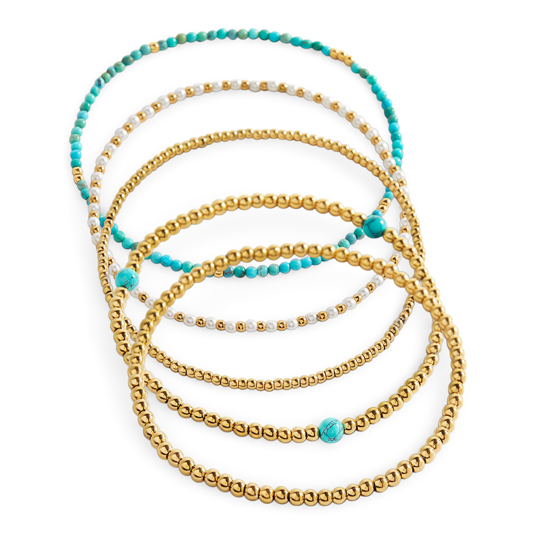 Set of gold and turquoise beaded bracelets on a white background