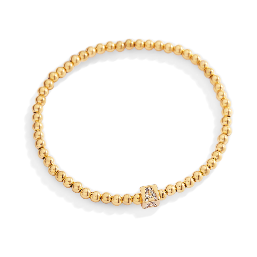 Gold beaded bracelet with a clasp on a white background