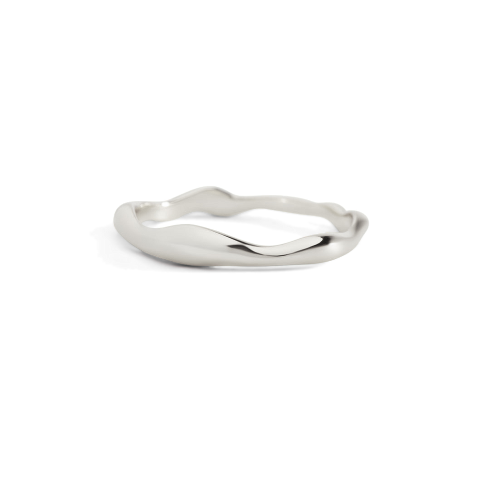 Silver ring with wavy design on a white background