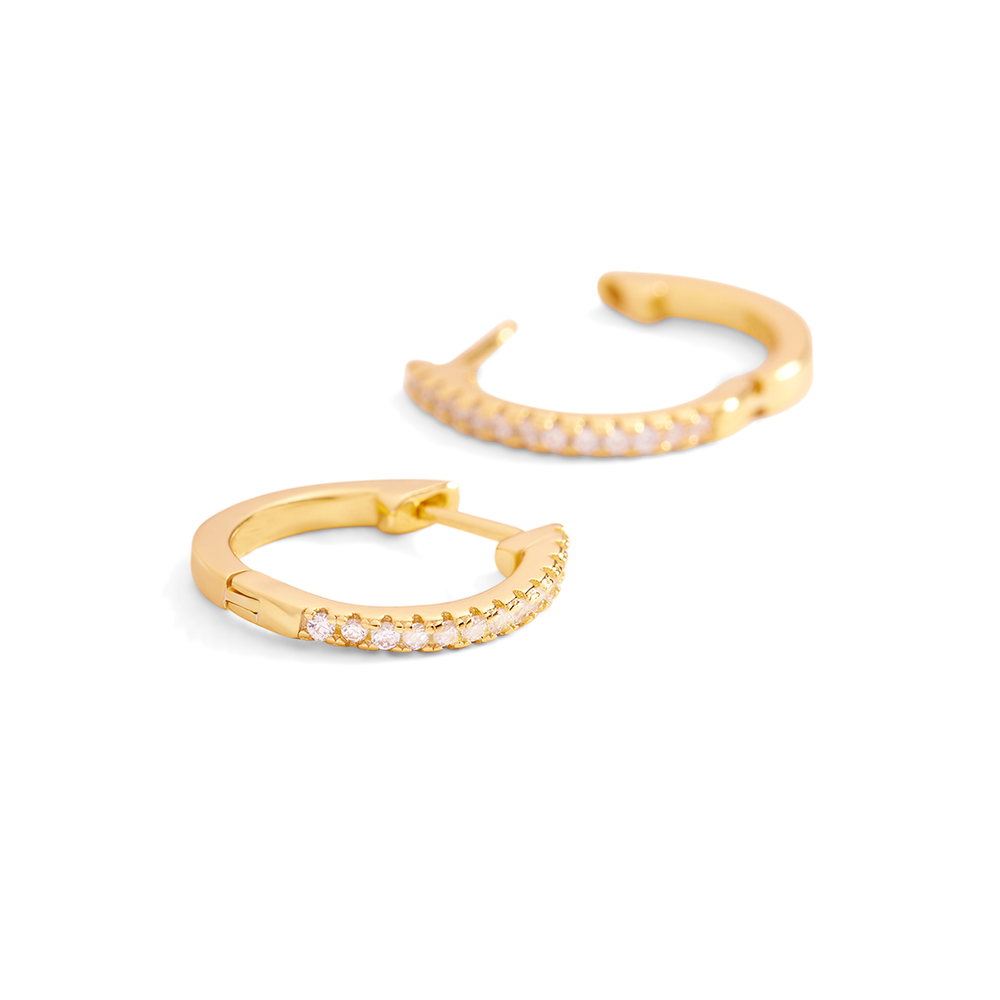 Two gold hoop earrings with small diamonds on a light gray background