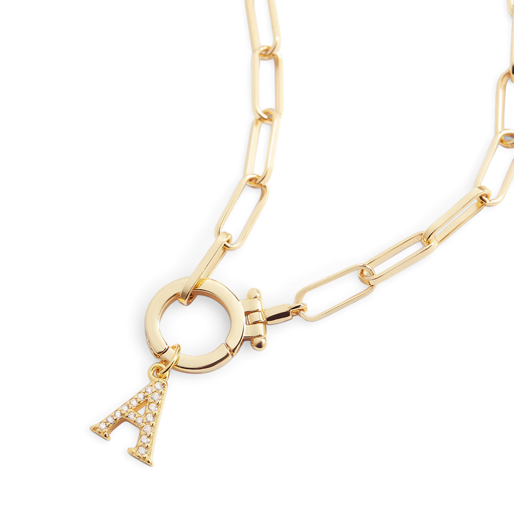 Gold chain necklace with a circular pendant and 'A' charm on a light gray background