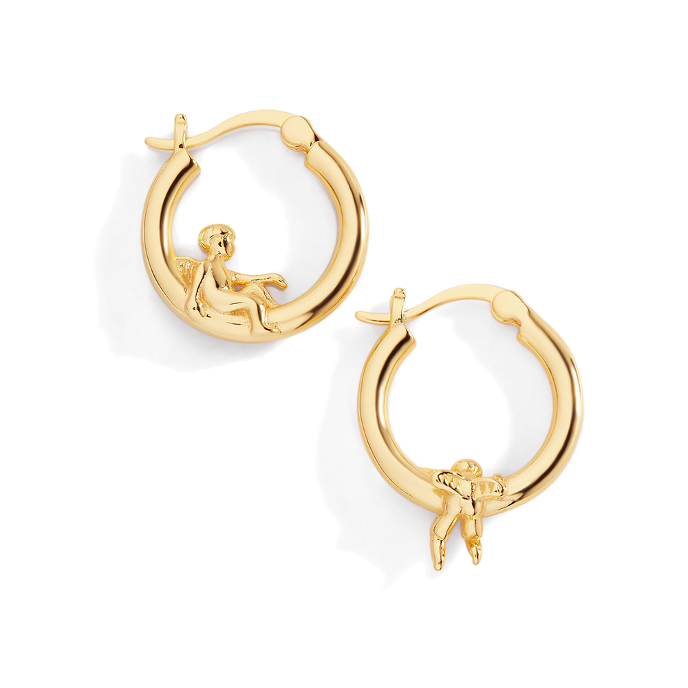 Gold hoop earrings with mermaid figures on a white background